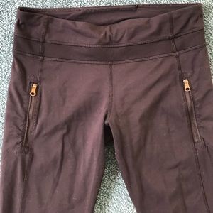 Lululemon leggings with gold zipper pockets and mesh ankle detail